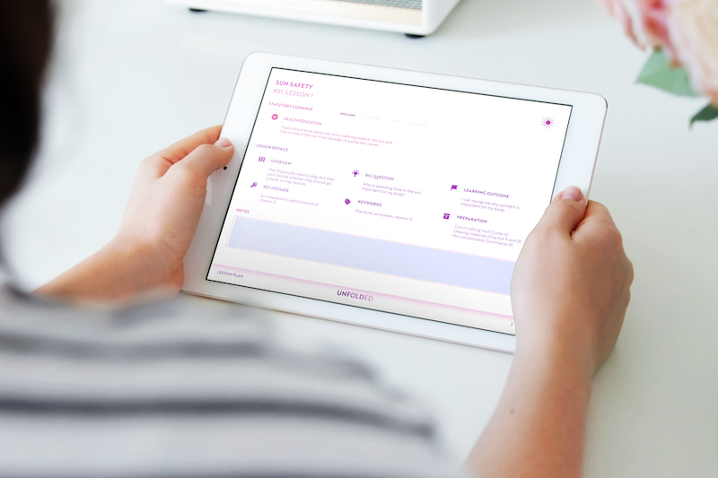 A teacher interacting with the Unfold PSHE lesson plan.