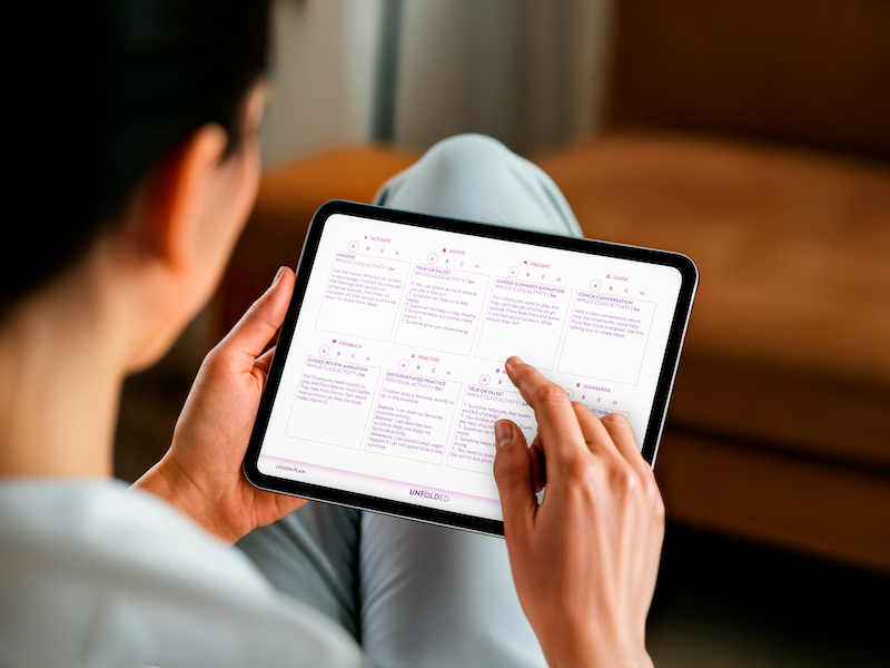 A teacher interacting with the Unfold PSHE lesson plan.